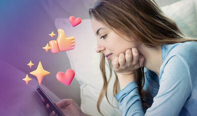 Junge Frau liegt auf dem Sofa mit dem Smartphone in der Hand