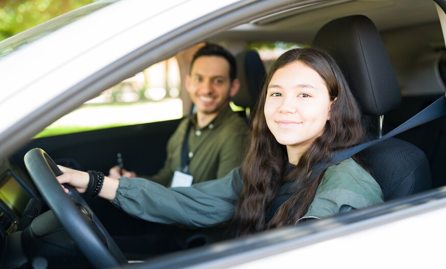 Junge Frau sitzt mit Mann im Auto