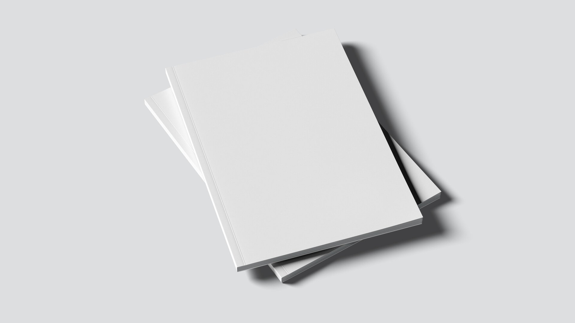 Zwei weiße Bücher mit Softeinband liegen auf weißem Tisch